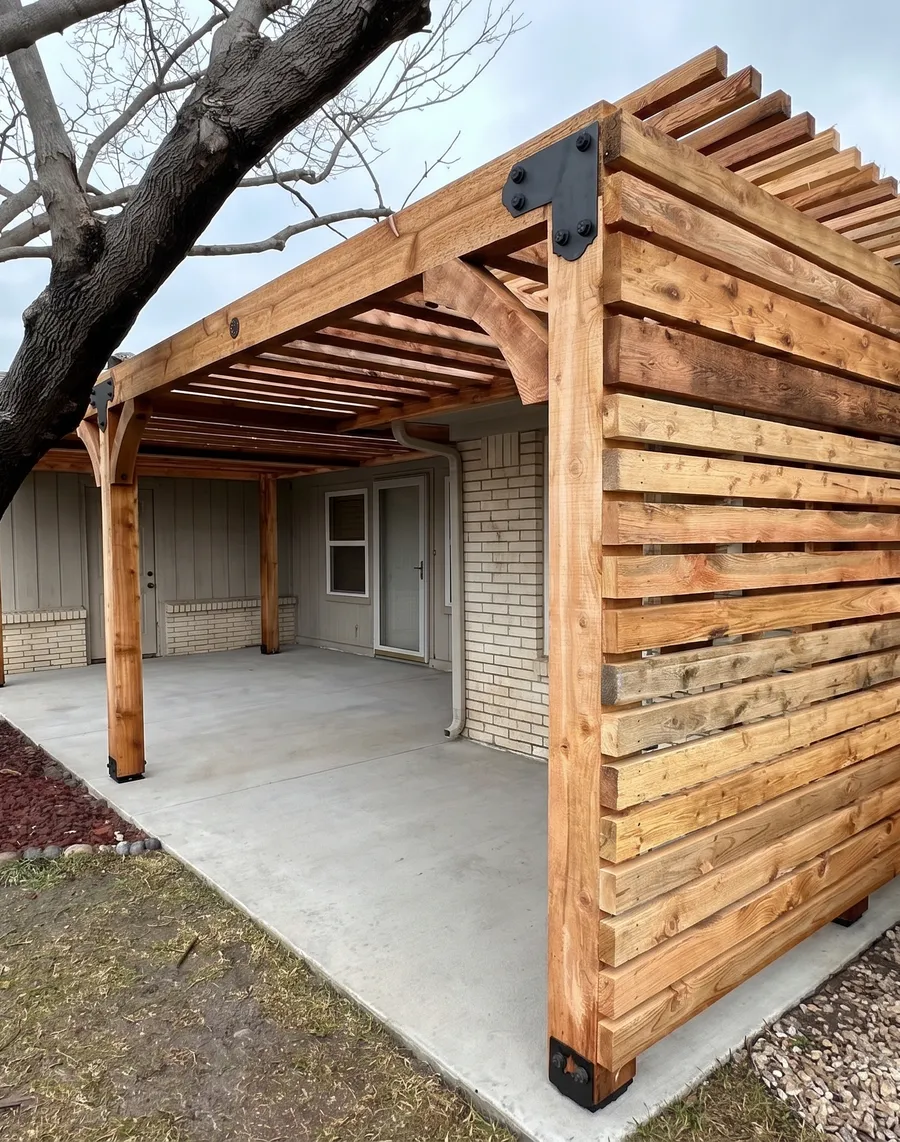 Cedar pergola with a horizontal slat privacy wall
